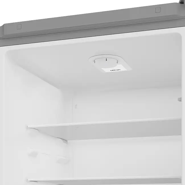 Interior view of Beko 50/50 combi fridge freezer showing white refrigerator compartment with adjustable shelving and temperature control dial on ceiling
