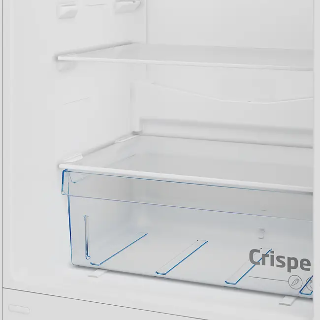Interior view of Beko CSG4582S combi fridge freezer showing empty white refrigerator compartment with transparent blue-handled crisper drawer and wire shelving