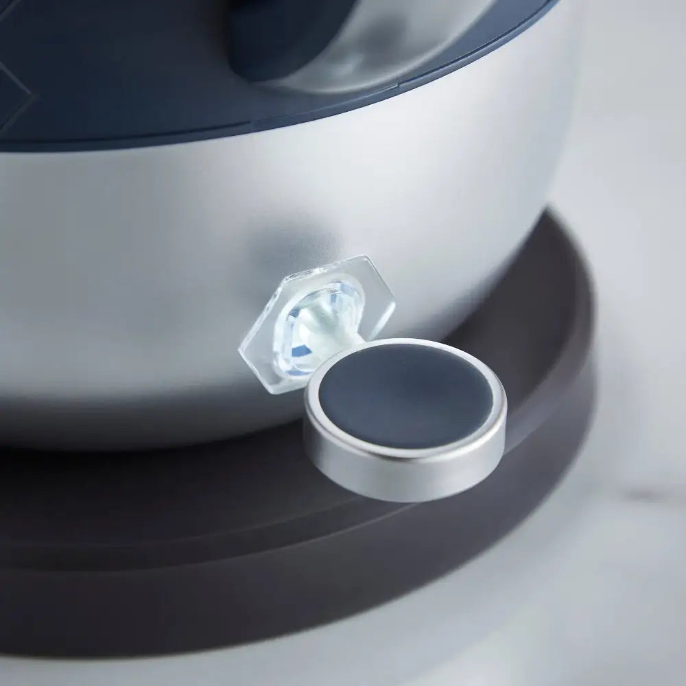 Close-up view of Morphy Richards Cassini kettle showing white and black jug with metallic silver trim, featuring a transparent water level window and modern minimalist design