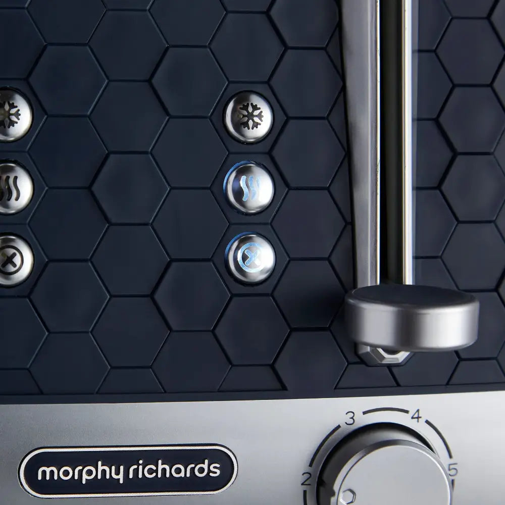 Morphy Richards Cassini 4 slice toaster in outer space black with hexagonal texture pattern, stainless steel accents, illuminated function buttons including defrost and reheat settings, and chrome lever handle with numbered heat dial control