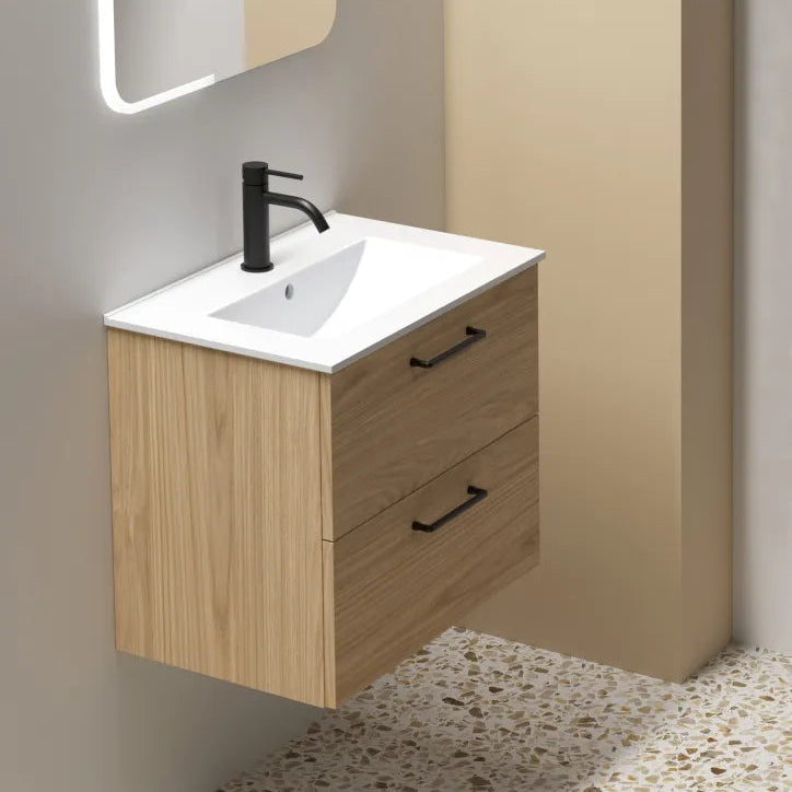 Modern light oak wall-hung bathroom vanity unit with white countertop, integrated white sink, black tap, two drawers with black handles, illuminated mirror, and terrazzo flooring