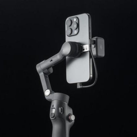 Phone holder attached to a gimbal on a black background