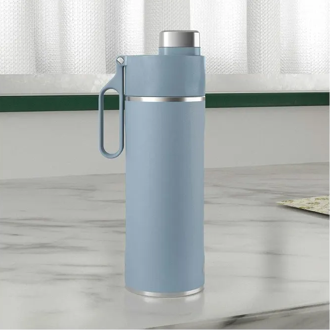 Ninja Thirsti 530ml insulated travel bottle in tropical blue with stainless steel trim and carabiner clip, displayed on a marble countertop