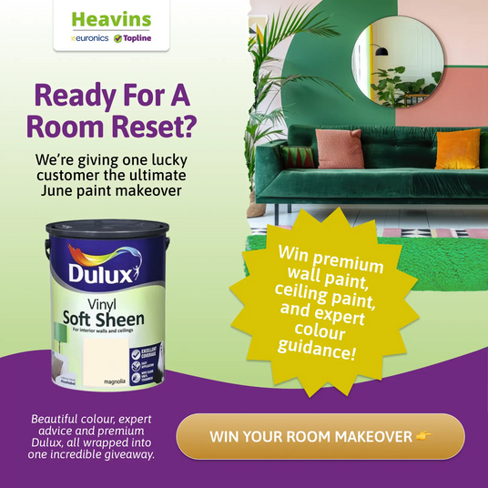 Promotional image for Dulux paint with a green sofa and decorative elements, featuring the Heavins brand.