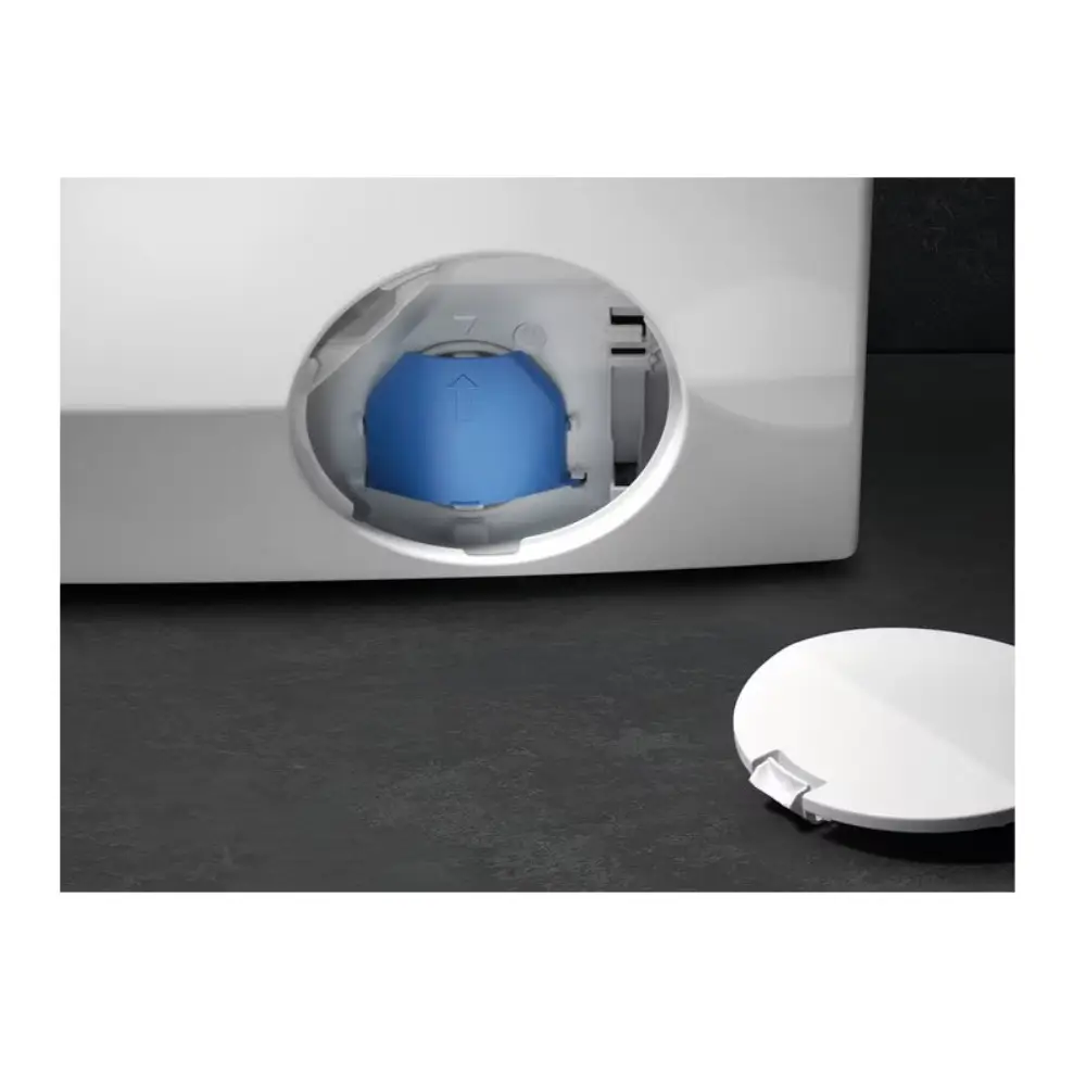 Front-loading white washing machine with blue detergent dispenser drawer open, showing 10kg capacity model on dark floor with white plate beside it