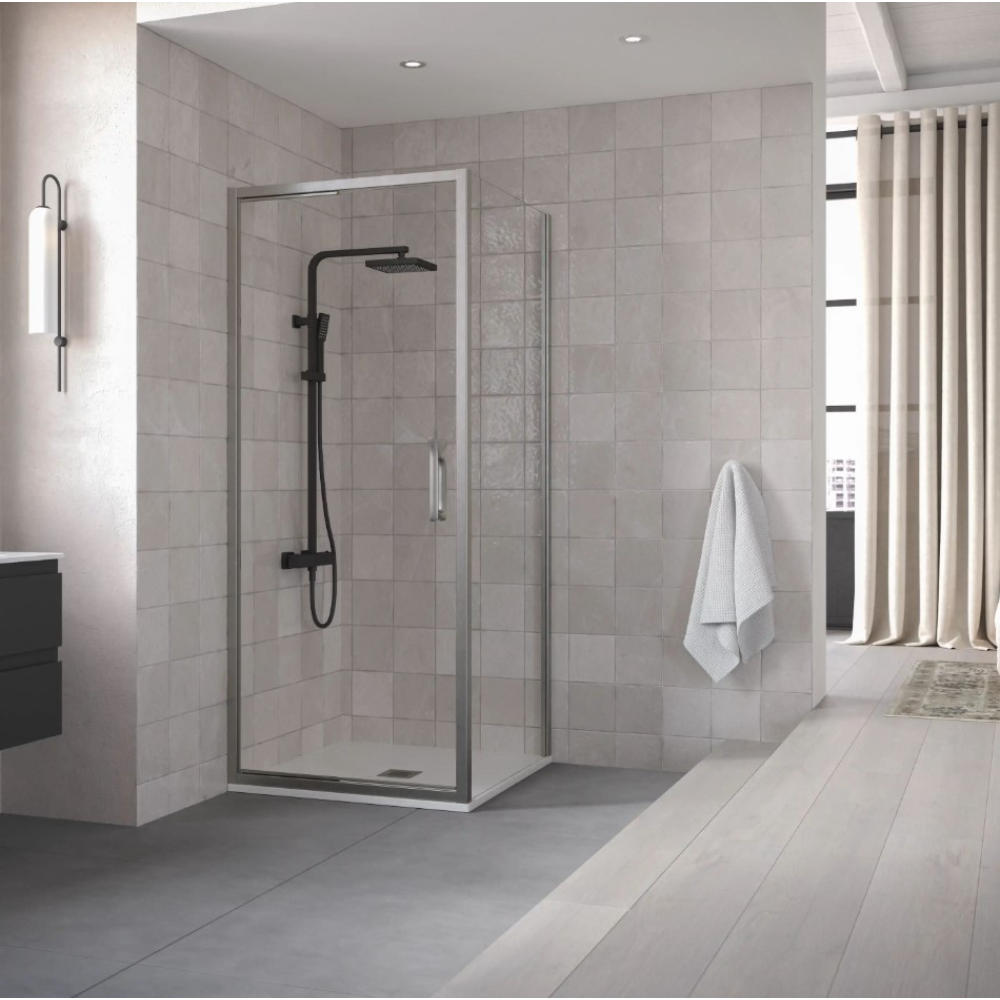 Flair ETO Infold Shower Door in chrome finish with black shower system installed in modern bathroom with grey tile walls and light wood flooring