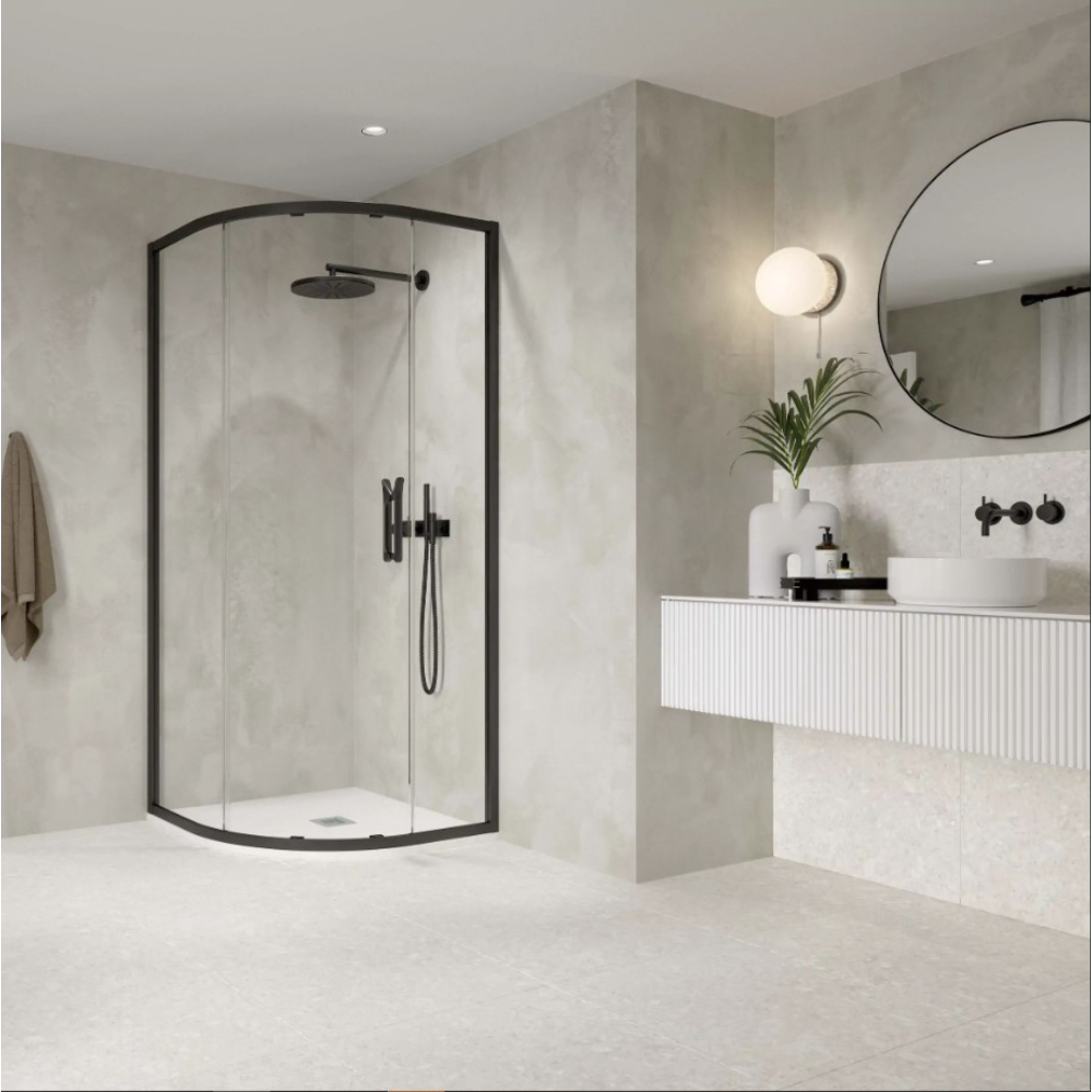 Modern bathroom featuring a Flair ETO Quadrant Shower Enclosure with matte black frame and clear glass doors, paired with a white wall-mounted vanity, round black mirror, and minimalist décor in neutral tones