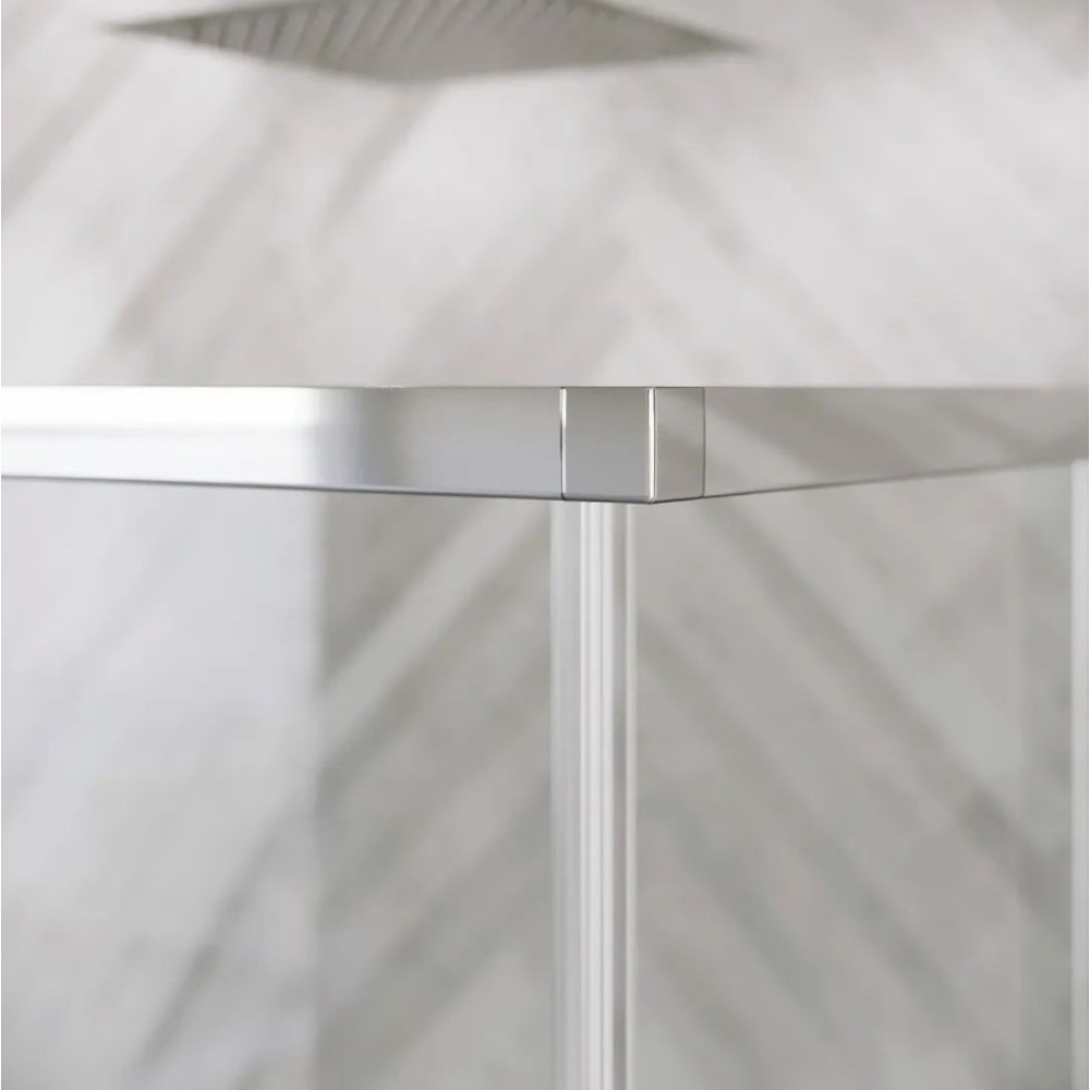 Close-up detail of Flair ETO Corner Entry Shower Enclosure showing chrome frame junction and vertical profile against white tiled walls with natural light shadows
