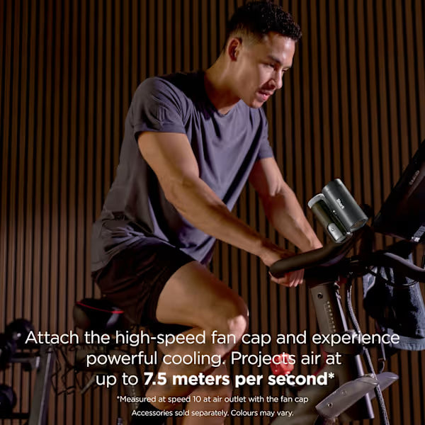 Man using a stationary bike with text about high-speed fan cap features.
