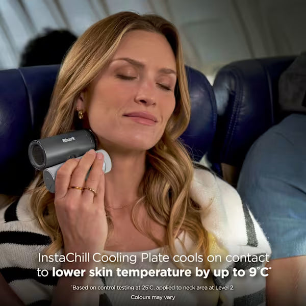 Woman using a Shark InstaChill cooling plate on an airplane seat