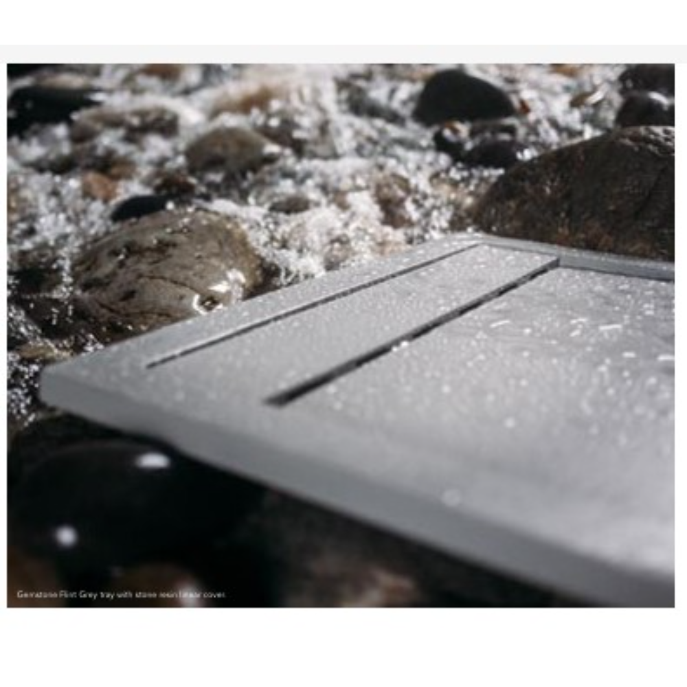 Flair Gemstone Slate rectangular tray in grey with linear detailing, displayed on decorative stones and pebbles outdoors