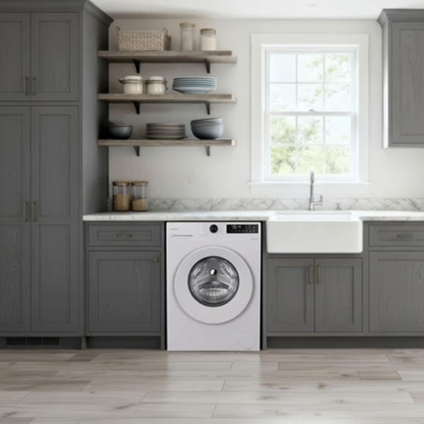 White Candy Quick Pro 8kg 1200 spin washing machine integrated into a modern gray laundry room with white farmhouse sink, marble countertop, floating shelves, and wood-look flooring