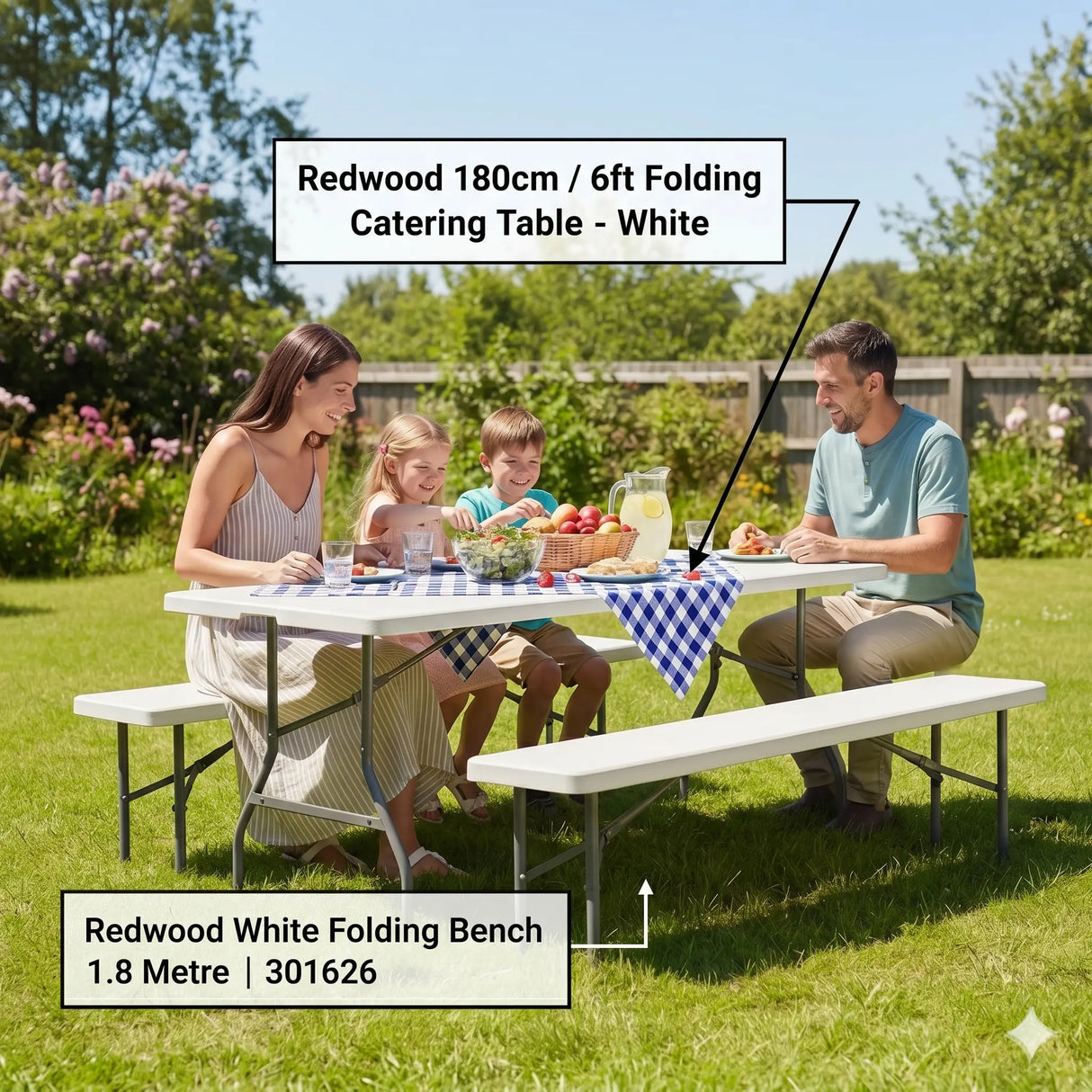 Family enjoying outdoor picnic at white Redwood 180cm folding catering table with matching white folding bench on grass garden setting with food, drinks and blue checkered tablecloth