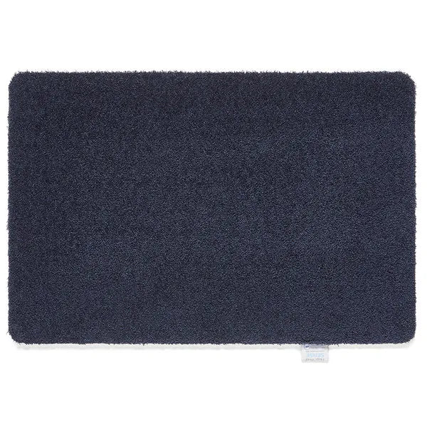 Dark navy blue textured doormat with rounded corners, 50cm x 75cm Hug Rug Sense design with small brand label visible in bottom right corner