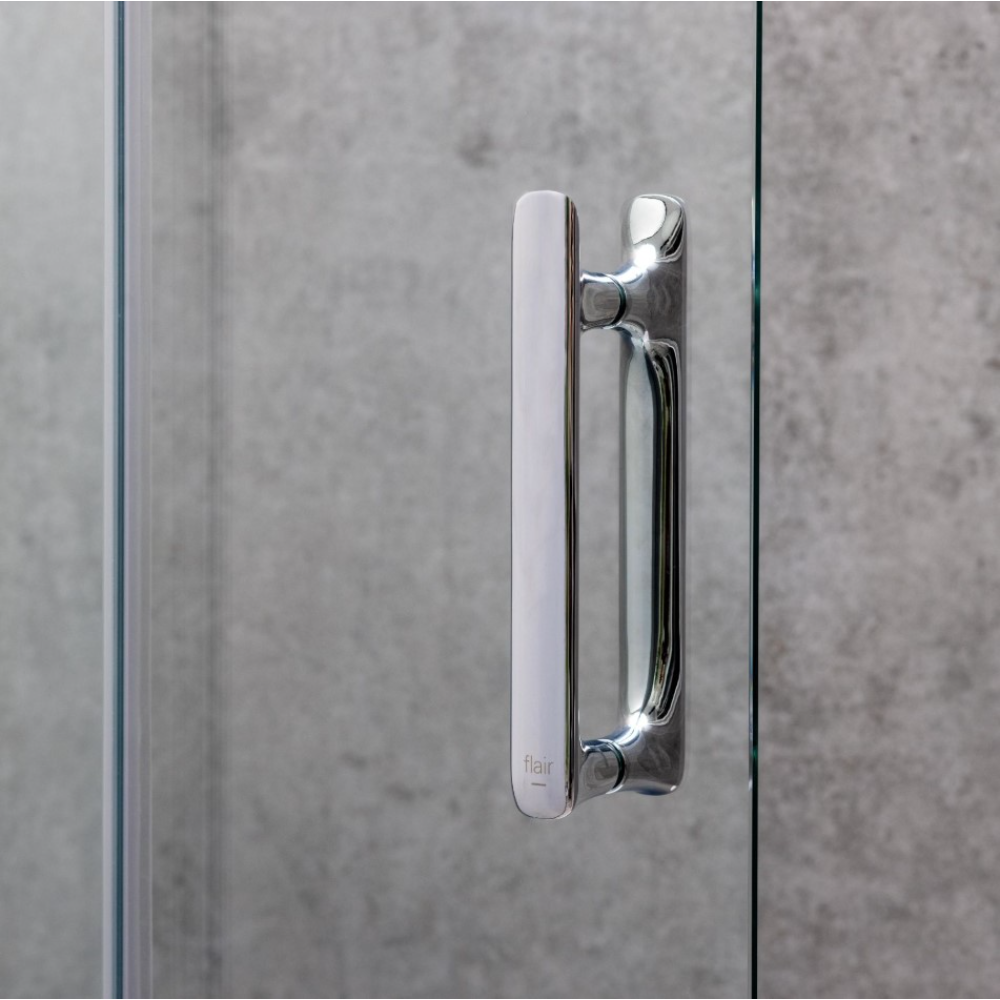Chrome and white handle detail of Flair ILI bifold shower door against grey concrete wall tile background