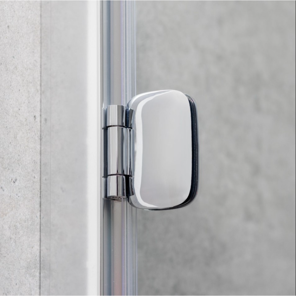 Close-up of a chrome and matte black hinge door frame showing a rounded rectangular mirror mounted on polished chrome hardware against a concrete wall background