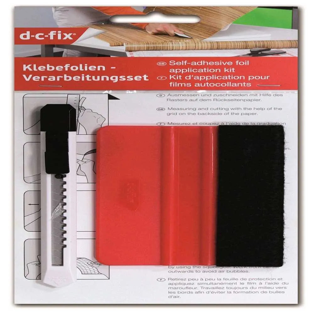 D-C-Fix self-adhesive foil application kit showing red and black adhesive sheets with white applicator tool and black serrated cutter knife on instruction card packaging