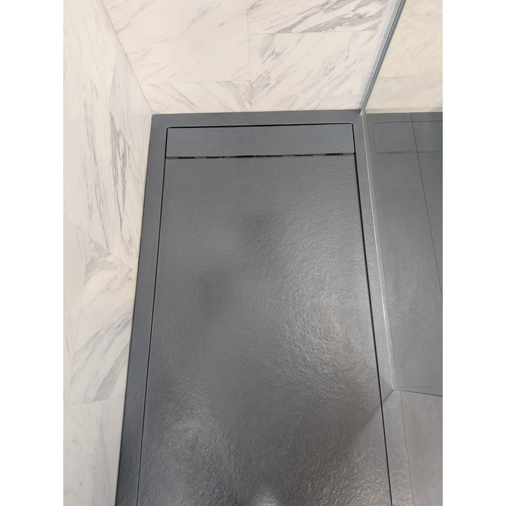 Flair Gemstone Slate rectangular shower tray in dark grey with raised rim and textured surface finish displayed in modern bathroom setting with marble-effect wall tiles