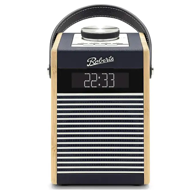 Roberts Rambler Midi DAB+ FM radio with Bluetooth in navy blue and natural wood finish, featuring digital display showing 22:33, horizontal stripe speaker grille, and black leather carrying handle