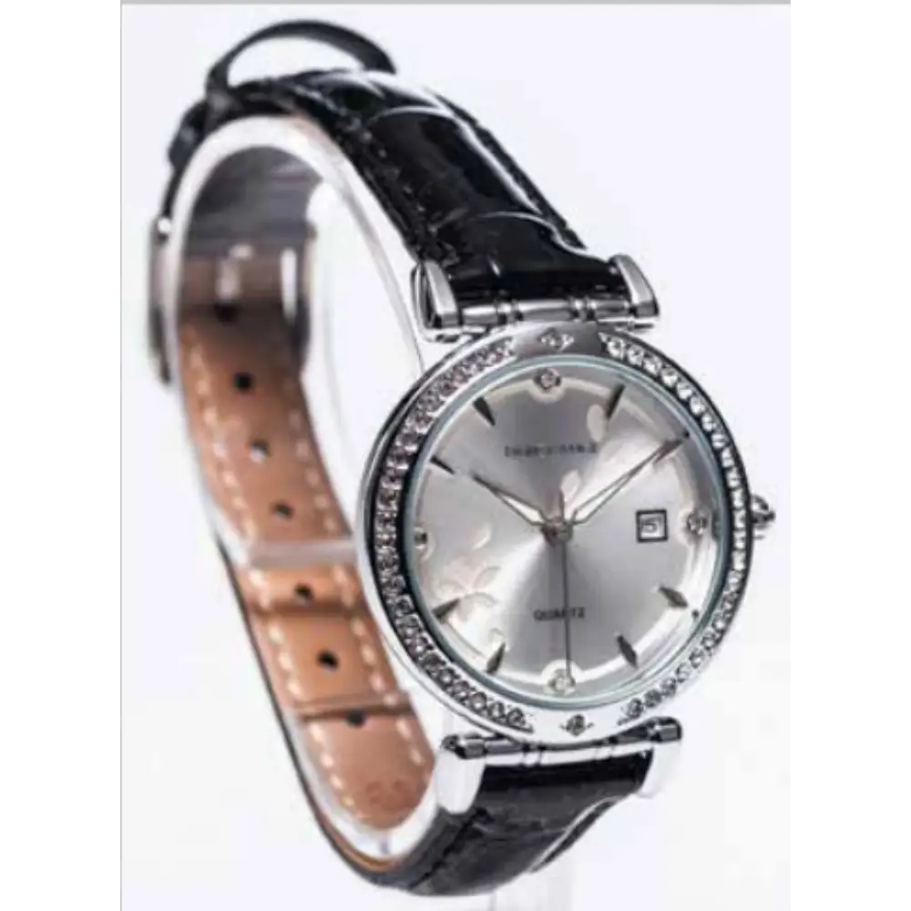 Newgrange Living Black Bezel Ladies Watch in silver with black leather strap, featuring a silver dial, crystal-studded bezel, date window, and tan perforated leather interior visible on band