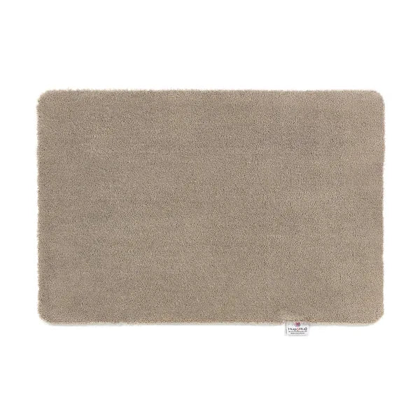 Hug Rug Doormat in Sense Beige, 50cm x 75cm rectangular mat with soft textured surface and rounded corners, featuring brand label tag