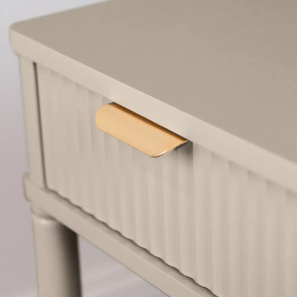 Close-up detail of Tara Lane Parson 1 Drawer Accent Table in oyster white with brass handle on fluted drawer front and wooden top surface