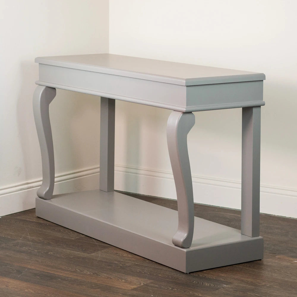 Tara Lane Scroll Console Table 130cm in mink grey finish with curved scroll legs and lower shelf, displayed on dark wood flooring against white walls