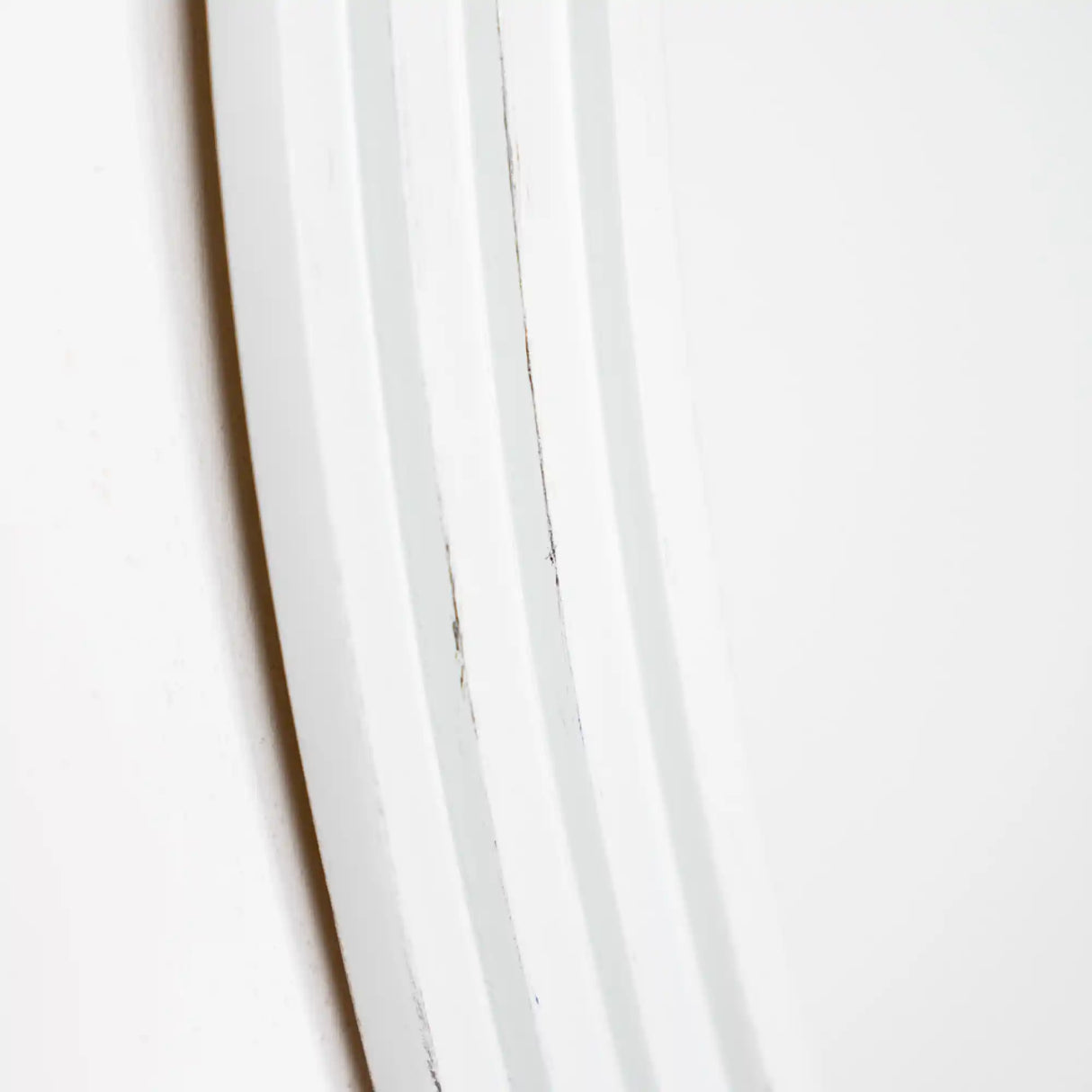 Close-up detail of white ribbed vertical slats showing texture and dimensional grooves on Tara Lane Stepped Round Wall Mirror in oyster finish