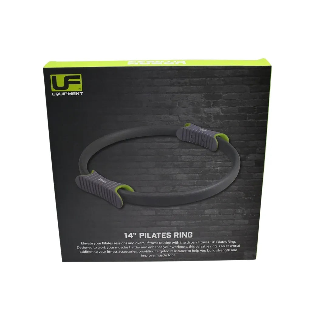Urban Fitness 14 inch Pilates Ring in black with grey and neon green foam handles on packaging against dark brick background