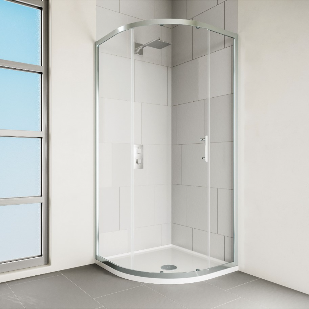 Modern chrome framed quadrant shower enclosure with curved glass doors, white curved tray base and grey tile surround in bright bathroom with window