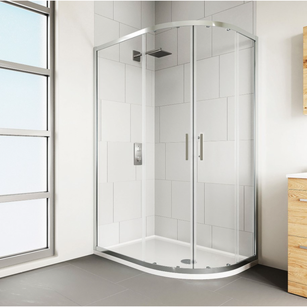 Modern chrome framed quadrant shower enclosure with clear glass panels and white curved base tray in contemporary bathroom with white subway tiles and wooden vanity