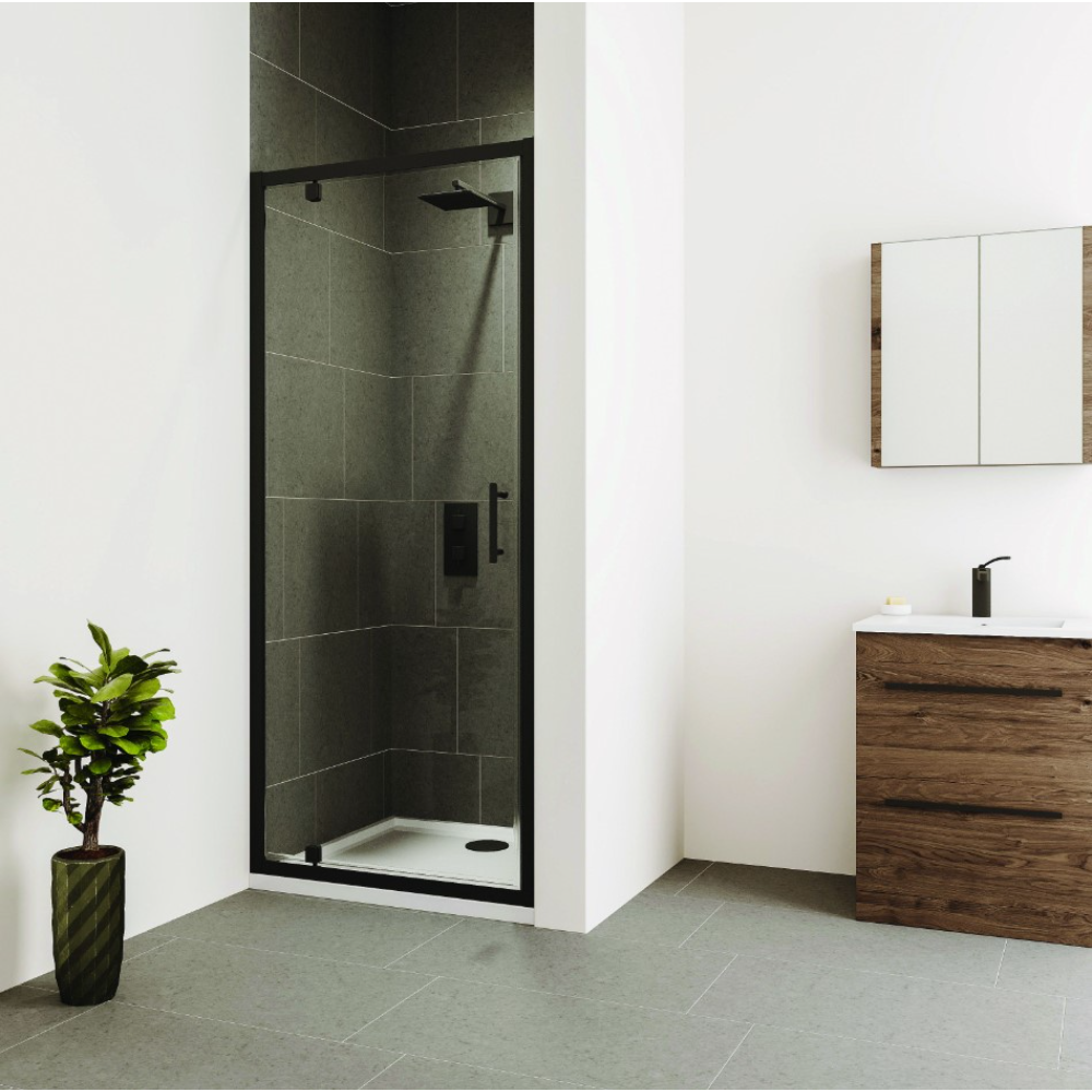Modern bathroom featuring Flair Verve Pro pivot shower door in black frame with dark green tile walls, adjacent to wooden vanity unit with white sink and mirror cabinet, grey floor tiles, and potted plant