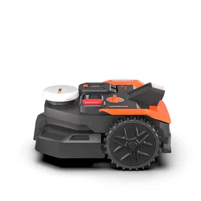 Worx Landroid Vision AI RTK autonomous robotic lawnmower with orange and black chassis, white charging dock, and rugged black wheel tread on white background