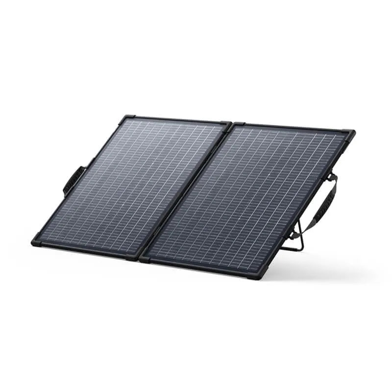 Anker SOLIX PS100 bifacial portable solar panel with two black-framed panels connected by hinges, featuring grey solar cells in a grid pattern, equipped with carrying handles, shown at an angled position against a white background