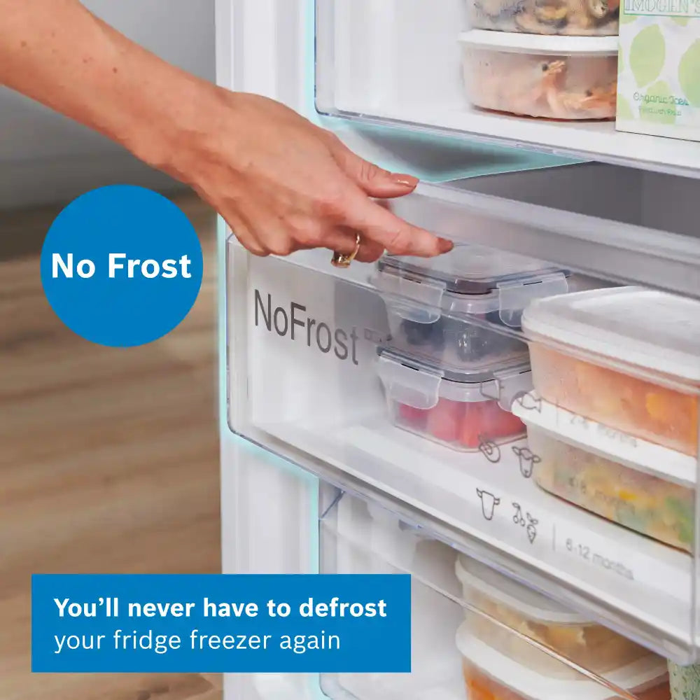 Hand reaching into a No Frost refrigerator with food containers inside, emphasizing the no-defrost feature.
