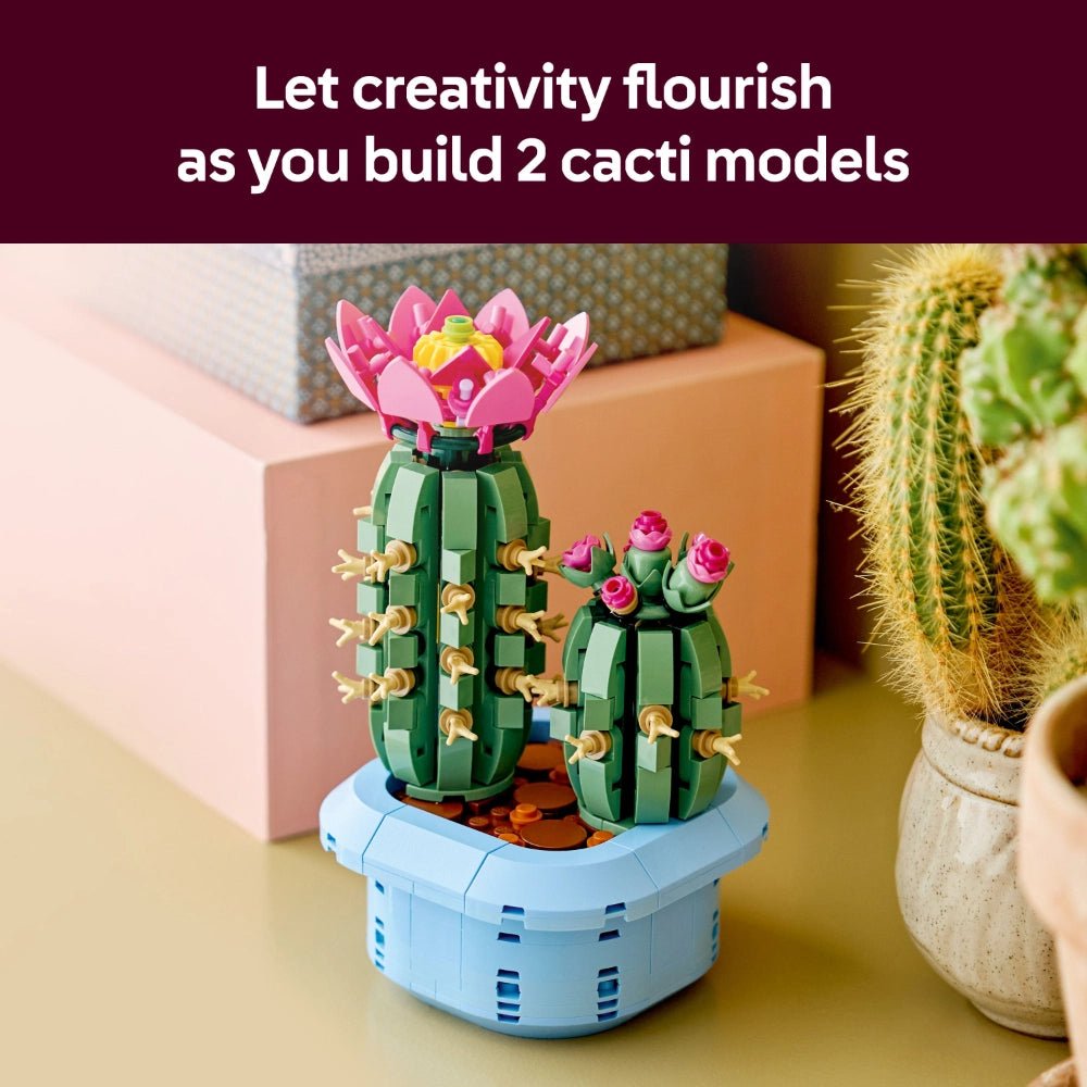 LEGO Flowering Cactus building set featuring two colorful cacti models with pink and red blooms in a light blue pot, displayed on a yellow surface alongside potted plants and decorative boxes
