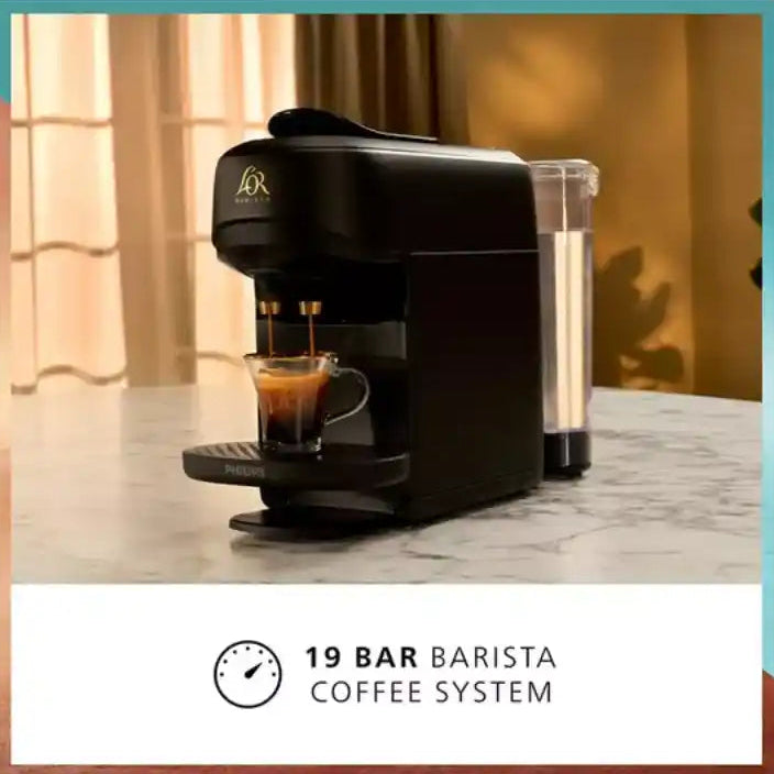 Philips L'OR Barista Absolu black coffee machine with 19 bar pressure system dispensing espresso into glass cup on marble countertop, featuring water reservoir and modern compact design