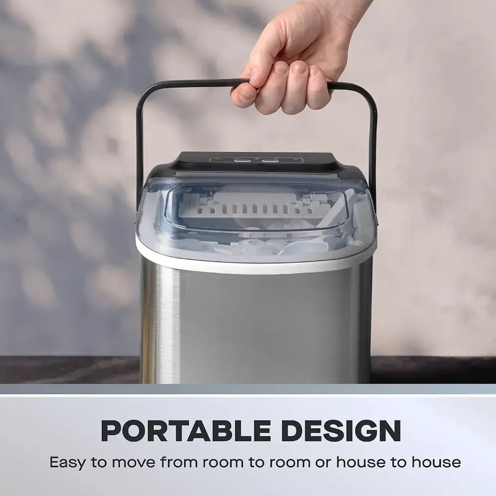 Portable stainless steel Daewoo ice cube maker with 1.2 litre tank and black carry handle being held up, showing transparent top lid and self-clean function controls