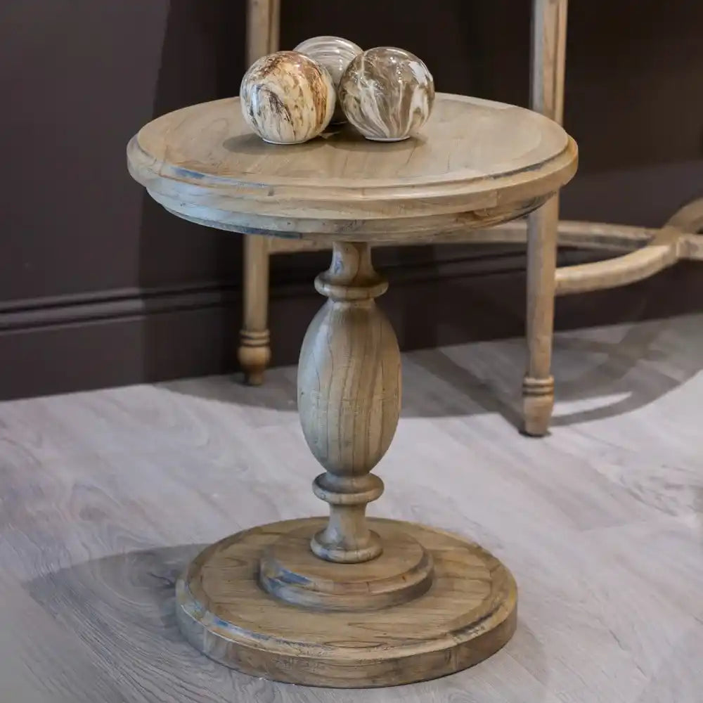 Tara Lane round pillar side table in natural wood finish with turned pedestal base, featuring two decorative marbled glass orbs on the circular top surface