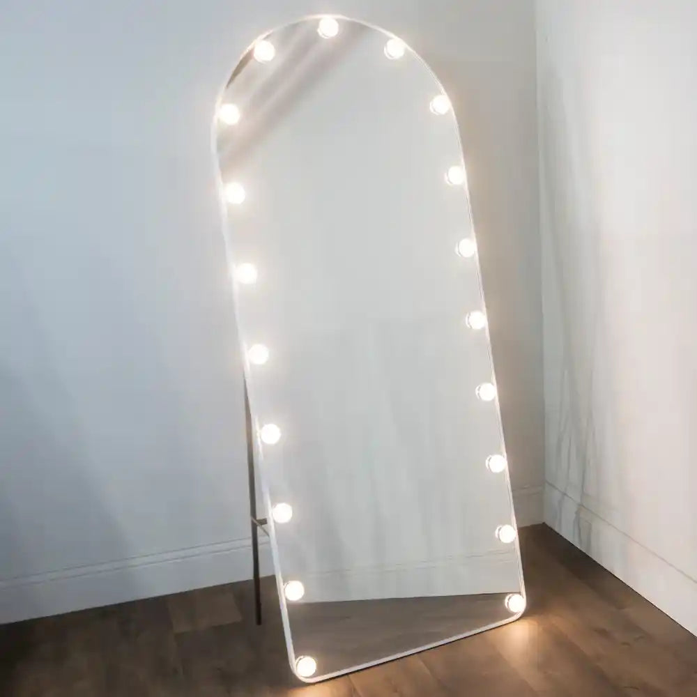 Tara Lane LED Bulb Modena Cheval Arch Mirror 160cm x 50cm in white with illuminated bulbs around the frame, leaning against white wall on wooden floor