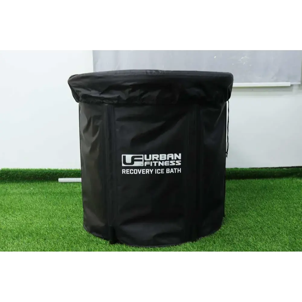 Urban Fitness Recovery Ice Bath black cylindrical tub 80cm x 75cm displayed on artificial grass against white wall background