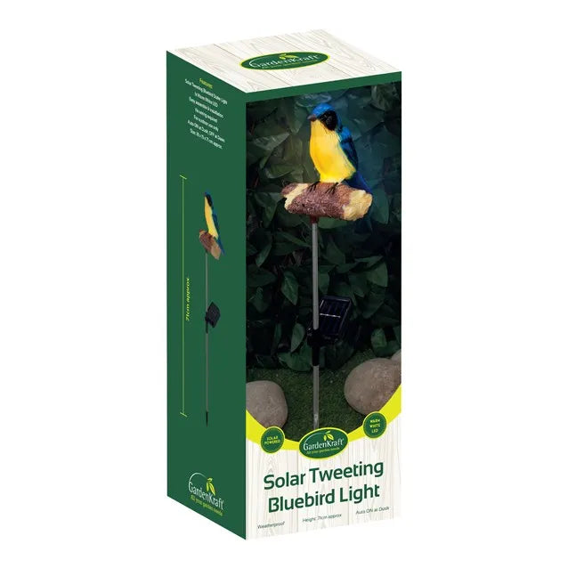 Gardenkraft Solar Tweeting Bluebird Light in packaging showing blue and yellow decorative bird perched on cork feeder with solar panel stake and green foliage background