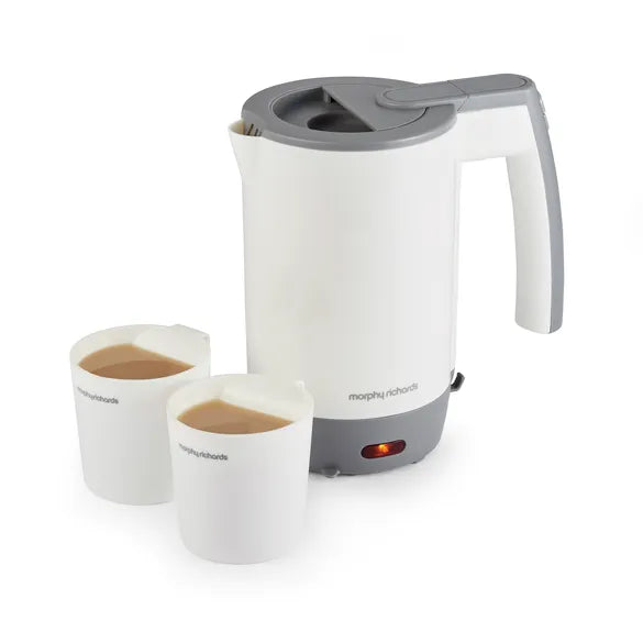 Morphy Richards compact travel kettle in white and grey with 0.5L capacity shown with two matching white cups filled with tea