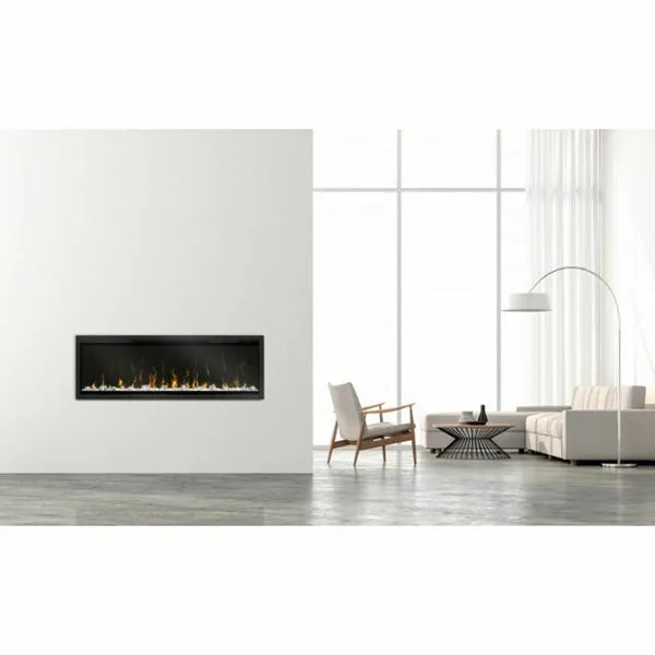 Dimplex IgniteXL 50 inch frameless electric fireplace with black surround mounted on white wall in modern minimalist living room with grey concrete floor, wooden armchair, curved floor lamp and white sofa