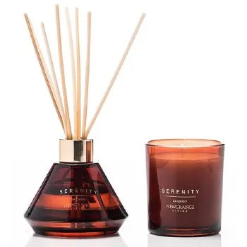 Serenity luxury candle and diffuser set with bergamot scent featuring an amber glass reed diffuser with wooden sticks and matching burgundy scented candle in glass jar