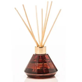 Newgrange Living luxury reed diffuser 100ml in deep amber glass with natural wooden sticks and gold cap, featuring Bergamot fragrance on white background