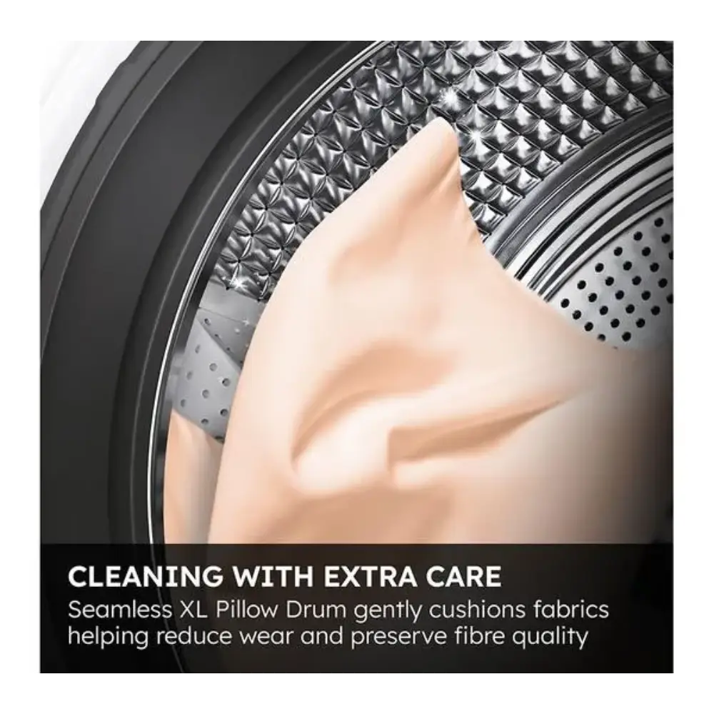 Close-up view of a Haier washing machine drum interior showing the seamless XL pillow drum design with textured metal surface and perforated holes, demonstrating gentle fabric care technology with a hand touching the soft drum surface against a dark background