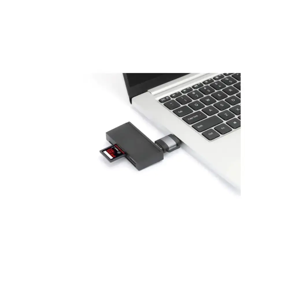 Black USB-C to USB-A dual adapter connected to silver MacBook laptop showing SD card slot and USB ports