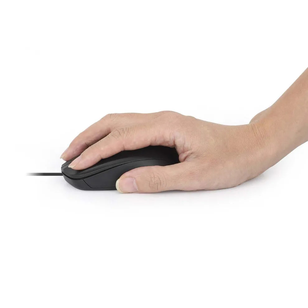 Hand holding a black Manhattan Comfort wired USB optical mouse against a white background, demonstrating ergonomic grip and design
