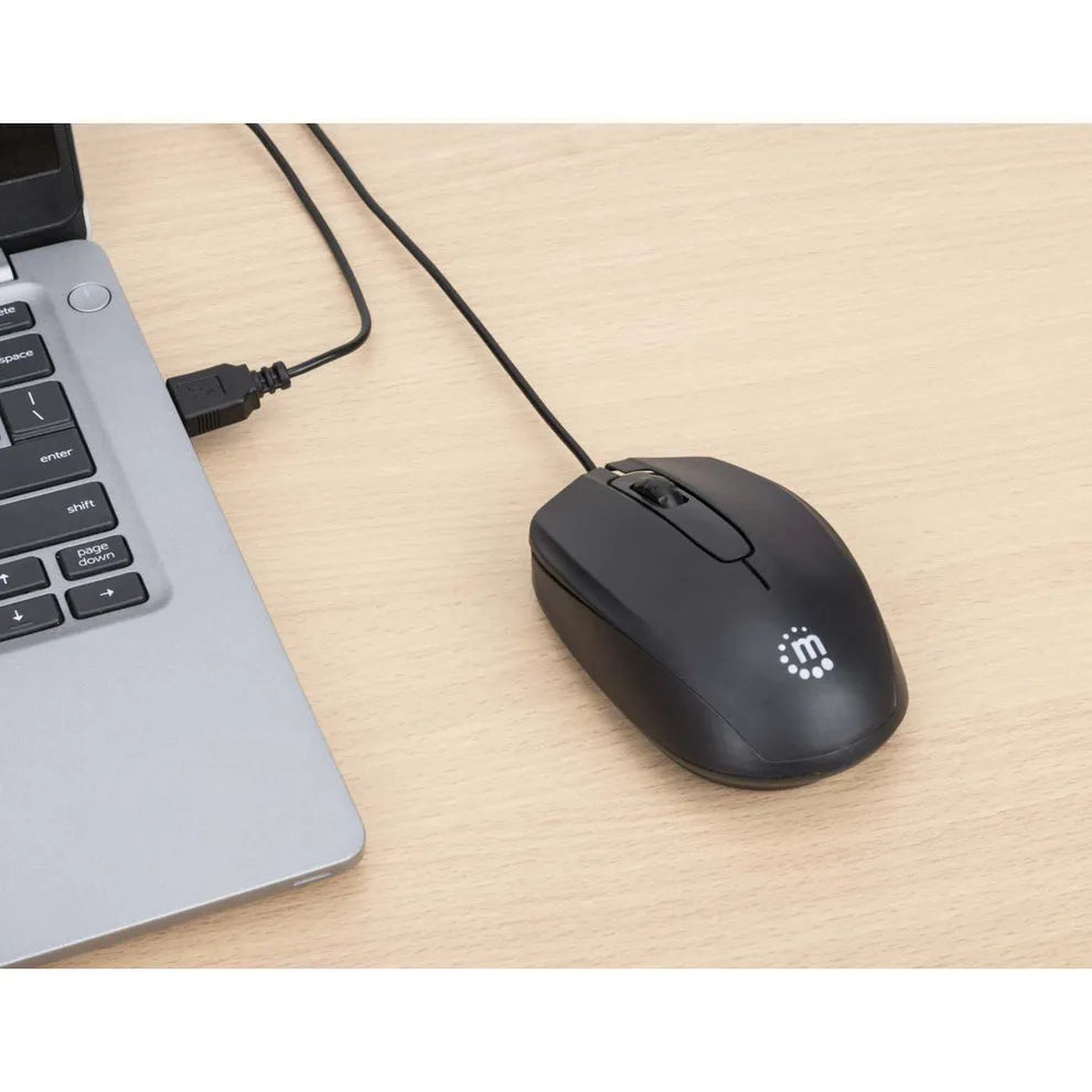 Black wired USB optical mouse with Manhattan Comfort branding connected to silver laptop on wooden desk